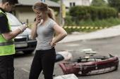 Young woman is terrified and telling policemen what happened 384619267