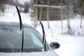 Windshield wiper raised up and icy car windshield. Leave Windshield Wipers Up in the Ice and Snow 2234108225