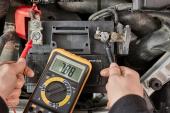 Car starter battery voltage measured with multimeter in a repair garage, bettry dead, time to replace 2086857775