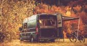 Scenic Recreational Vehicle RV Camping Spot with Fall Foliage Scenery. Class B Motorhome Boondocking in the Remote Place. Outdoor and Recreation Theme.
