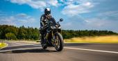 motorbike on the road riding. having fun driving the empty road on a motorcycle tour journey. copyspace for your individual text. Fast Motion Blur effect