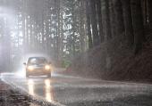 Car riding under heavy rainfall.