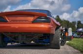 Power drifting car from side. back view
