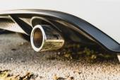 London, UK - Circa February 2022: Shallow focus of a metal exhaust, one either side of this high performance, German made hatchback car. A rear spoiler is also visible.